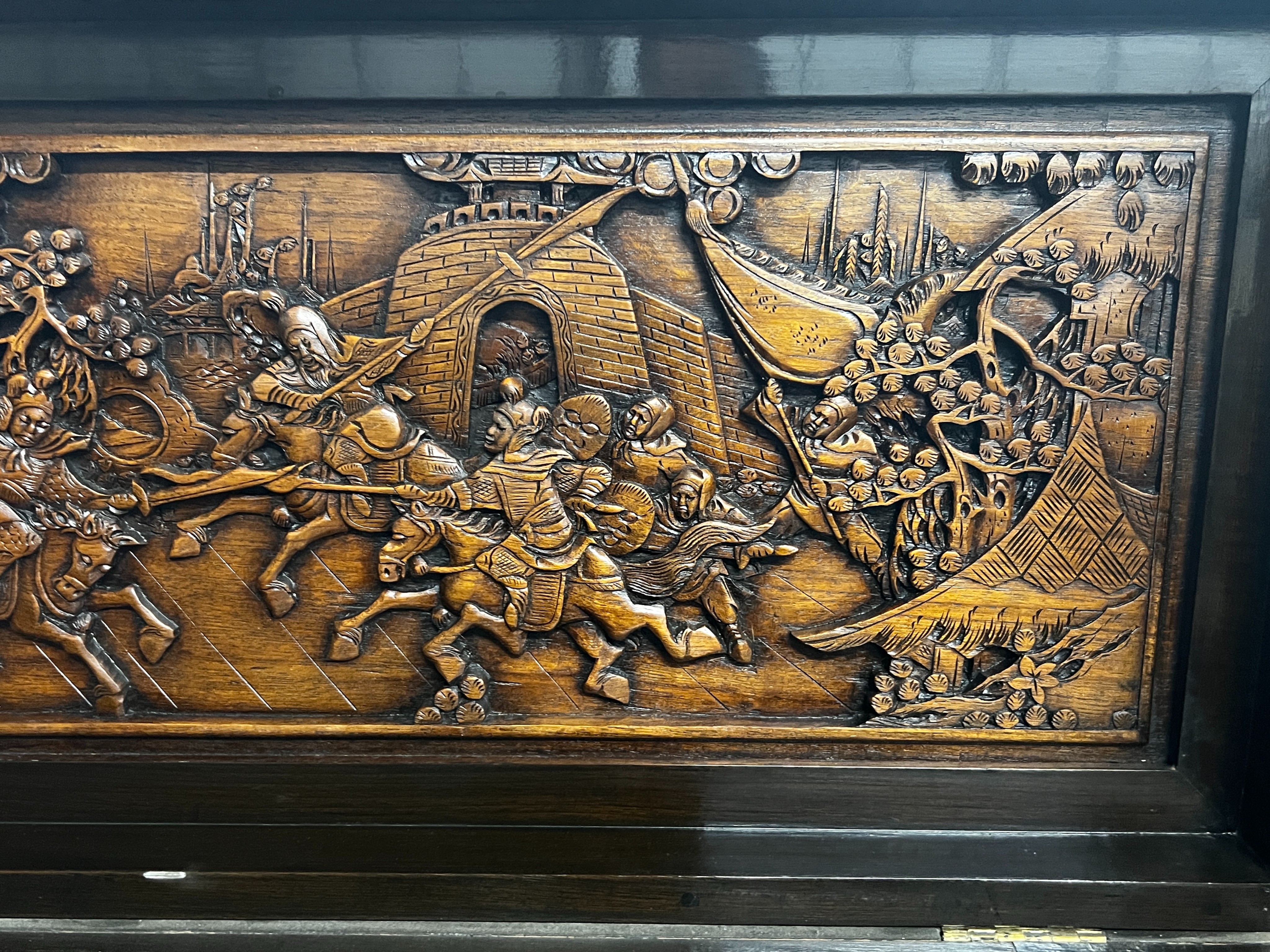 A Chinese carved hinged top cocktail cabinet with mirrored interior, width 111cm, depth 46cm, height 107cm